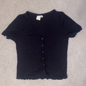 Black t shirt with buttons down the front.